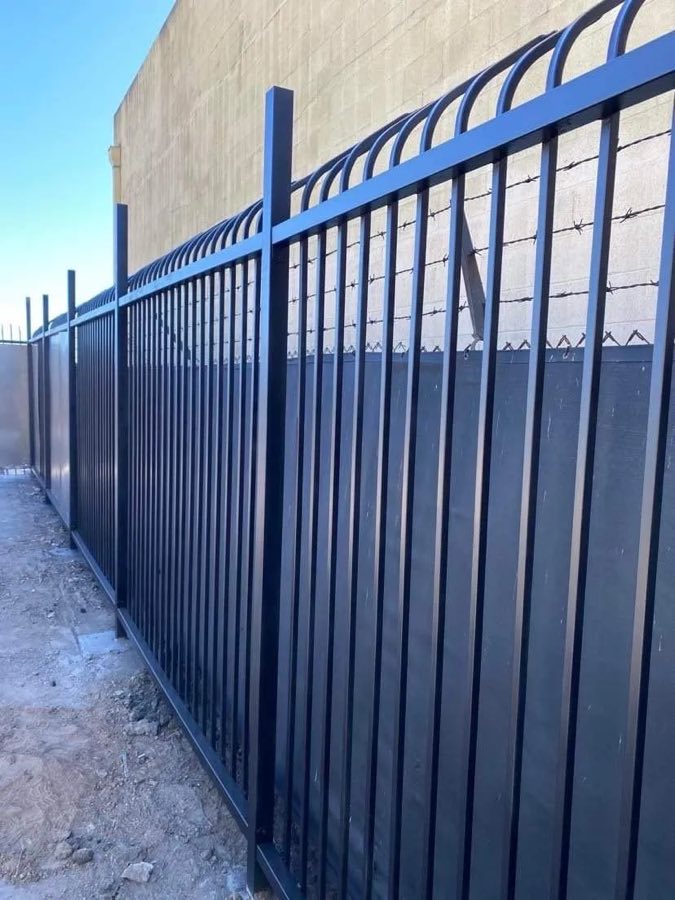Blue wrought iron fence with spear tops